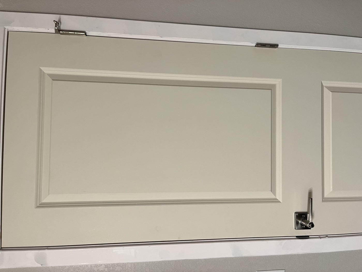 The same door after repainting, warm greige finish